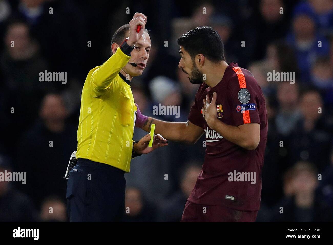 Soccer Football - Champions League Round of 16 First Leg - Chelsea vs FC Barcelona - Stamford Bridge, London, Britain - February 20, 2018   Barcelona’s Luis Suarez is shown a yellow card by referee Cuneyt Cakir   REUTERS/Eddie Keogh Stock Photo