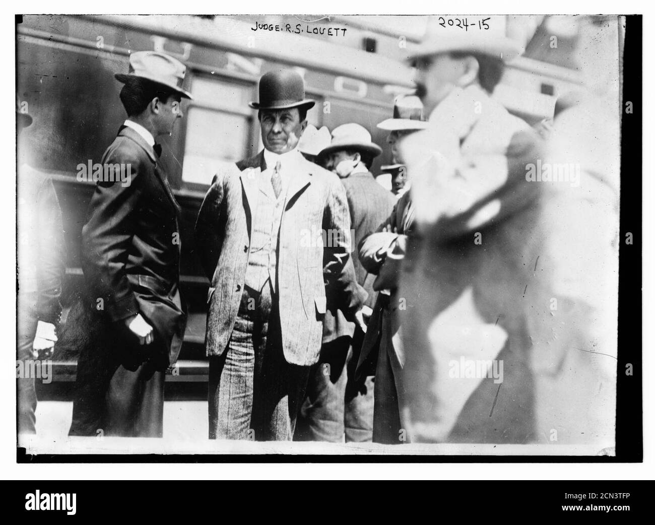 Judge R.S. Louett; Three-quarter view of Louett standing with a group of men in front of train Stock Photo