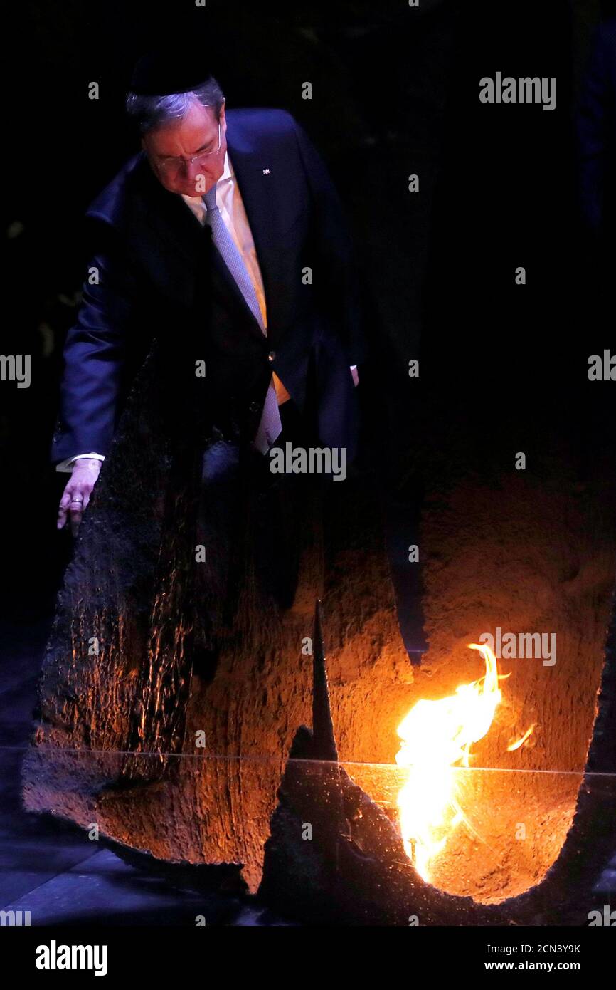 German politician Armin Laschet, Minister-President of Nordrhein-Westphalen, rekindles the eternal flame during a ceremony commemorating the six million Jews killed by the Nazis in the Holocaust, in the Hall of Remembrance at Yad Vashem Holocaust memorial centre in Jerusalem March 1, 2020. REUTERS/Ronen Zvulun Stock Photo