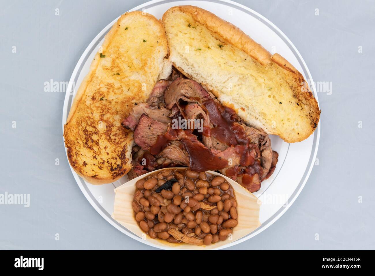 Overhead view of BBQ meal of tritip, baked beans, and butter toasted