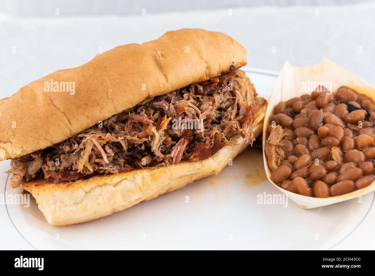 BBQ meal of pulled pork, baked beans, and butter toasted bread will