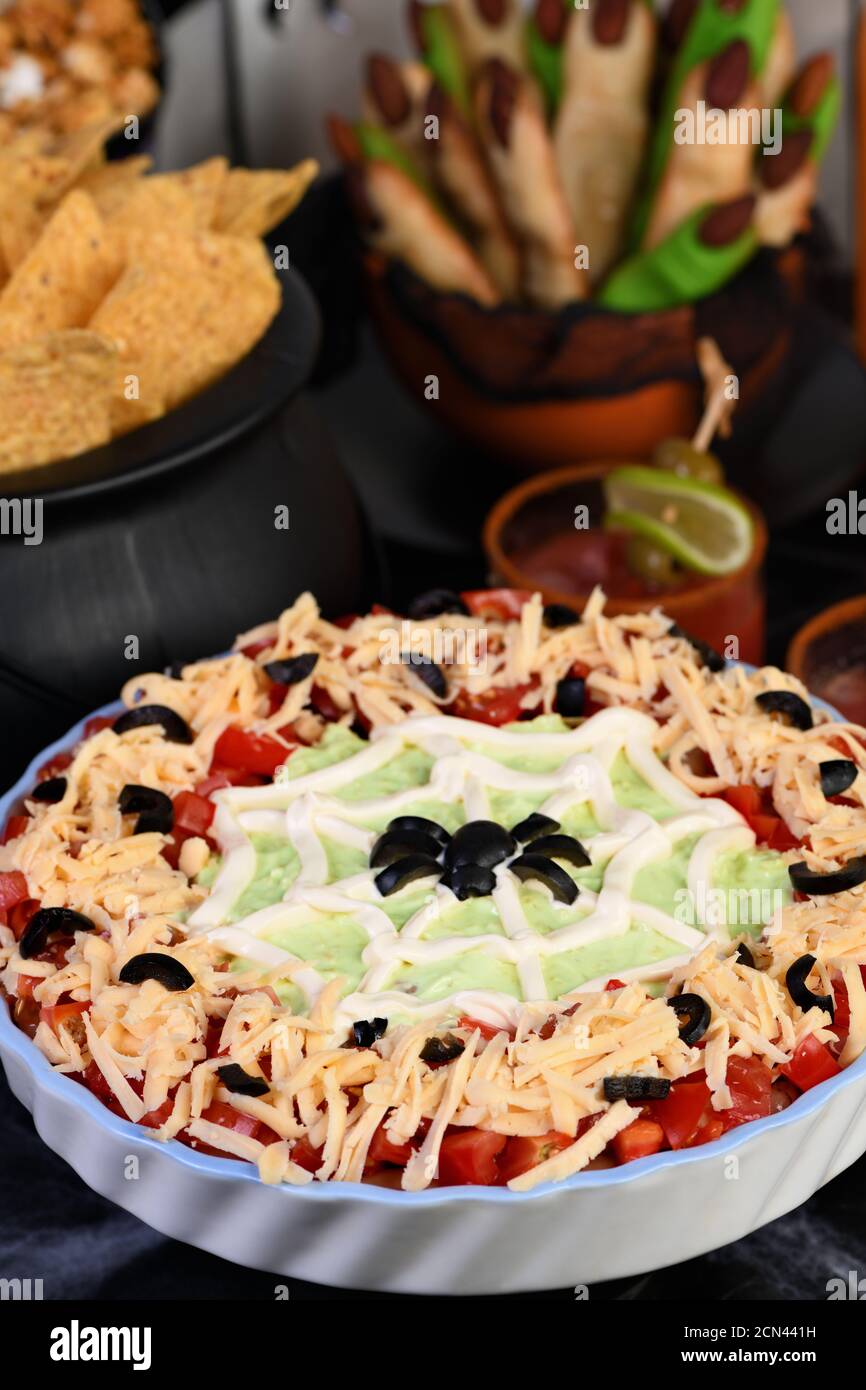 Spooky Halloween Seven Layer Taco Dip Turn a classic appetizer into a