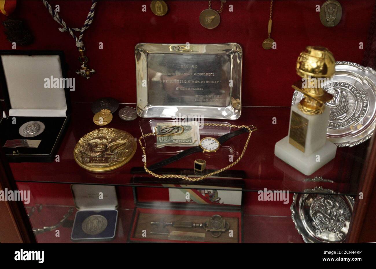 Medals, awards and other belongings of Mexican legendary comedian actor Mario Moreno 'Cantinflas' are seen in a glass cabinet at the Mario Moreno Foundation in Mexico City August 8, 2011. Mexico will celebrate the birthday of Cantinflas, who would have been 100 years old on August 12, with exhibitions of photographs and screenings of some of his most celebrated movies along the capital. Picture taken August 8, 2011. REUTERS/Henry Romero (MEXICO - Tags: ENTERTAINMENT SOCIETY ANNIVERSARY) Stock Photo
