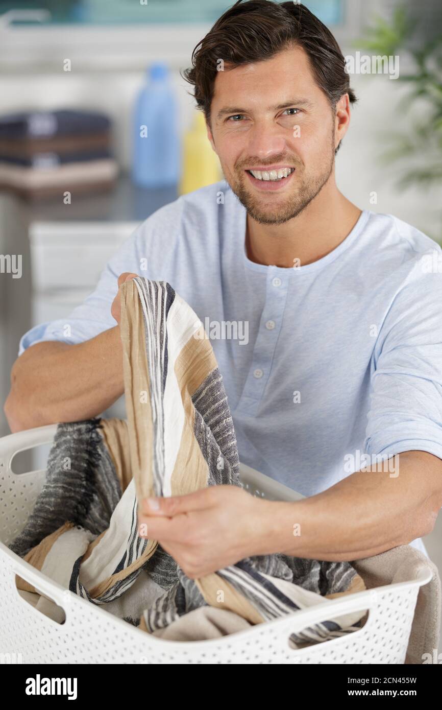 happy man with a laundry basket Stock Photo Alamy