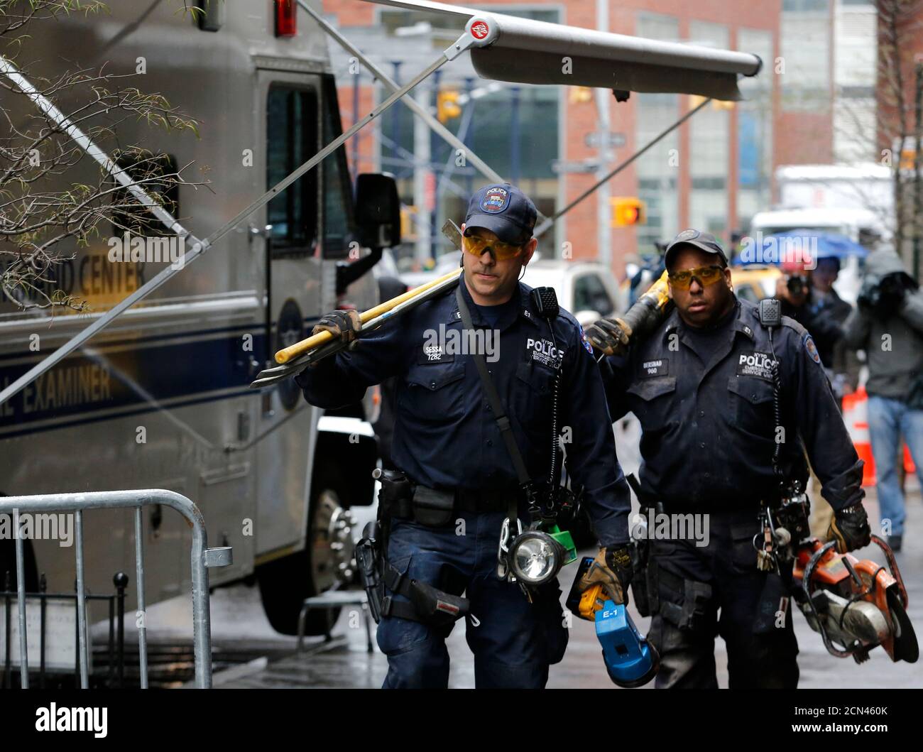 Members of the New York Police Department Emergency Service Unit exit 51 Park Place in New York, April 29, 2013. A Boeing representative confirmed to the New York Police Department that wreckage discovered last week, in a narrow alleyway behind 51 Park Place and 50 Murray Street in Manhattan's financial district, 'is believed to be from one of the two aircraft destroyed on September 11, 2001, but it could not be determined which one,' Paul Browne, NYPD's chief spokesman, said on Monday.  REUTERS/Brendan McDermid (UNITED STATES - Tags: TRANSPORT DISASTER CRIME LAW) Stock Photo