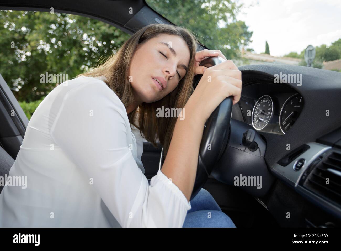 drunk woman sleeping on car wheel Stock Photo - Alamy
