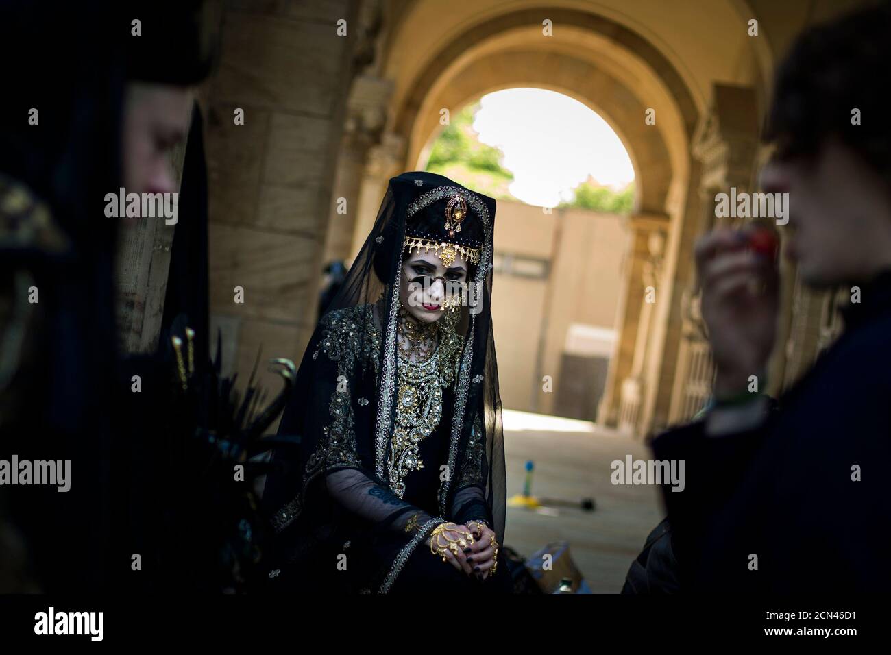 Revellers sit on the steps of the crematorium at the southern cemetery in Leipzig during the Wave and Goth festival June 7, 2014. The annual festival, known in Germany as Wave-Gotik Treffen (WGT), features over 150 bands and artist in venues all over the city playing Gothic rock and other styles of the dark wave music subculture. The event that counts as one of the biggest of its kind attracts a regular audience of up to 20,000 the organisers said.  REUTERS/Thomas Peter (GERMANY  - Tags: SOCIETY) Stock Photo