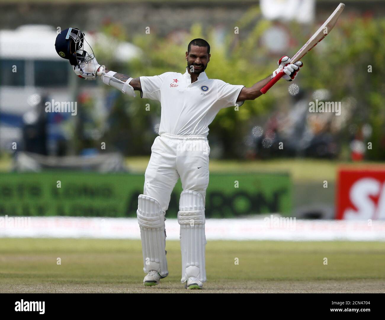 India's Shikhar Dhawan celebrates his century during the second day of their first test cricket match against Sri Lanka in Galle, August 13, 2015. REUTERS/Dinuka Liyanawatte Stock Photo