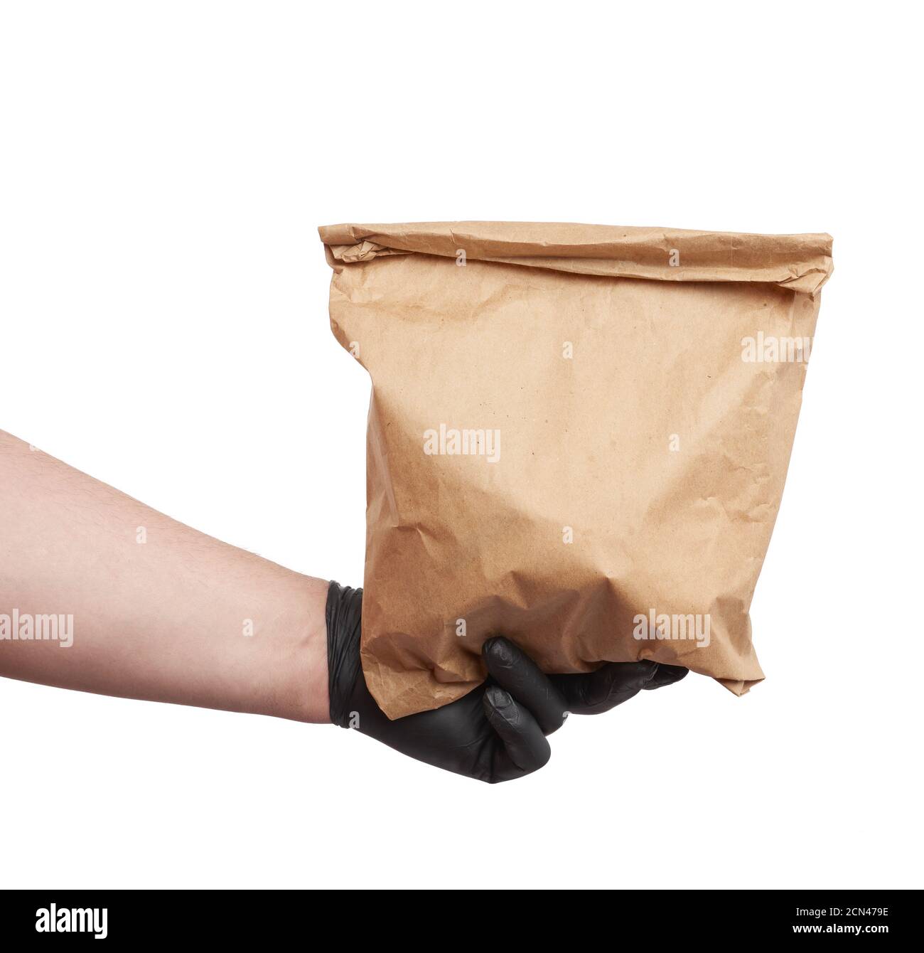 hand in a black latex glove holds a full paper bag of brown craft paper ...