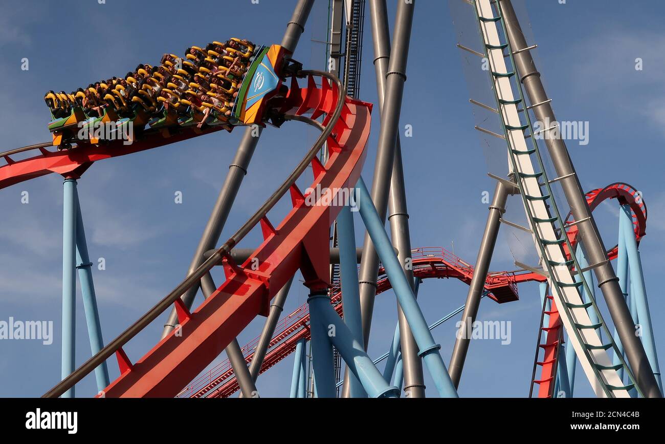 People ride in the 'Dragon Khan' roller coaster (red track) through  'Shambhala' at PortAventura resort, south of Barcelona, Spain July 25, 2017.  Picture taken July 25, 2017. REUTERS/Albert Gea Stock Photo - Alamy