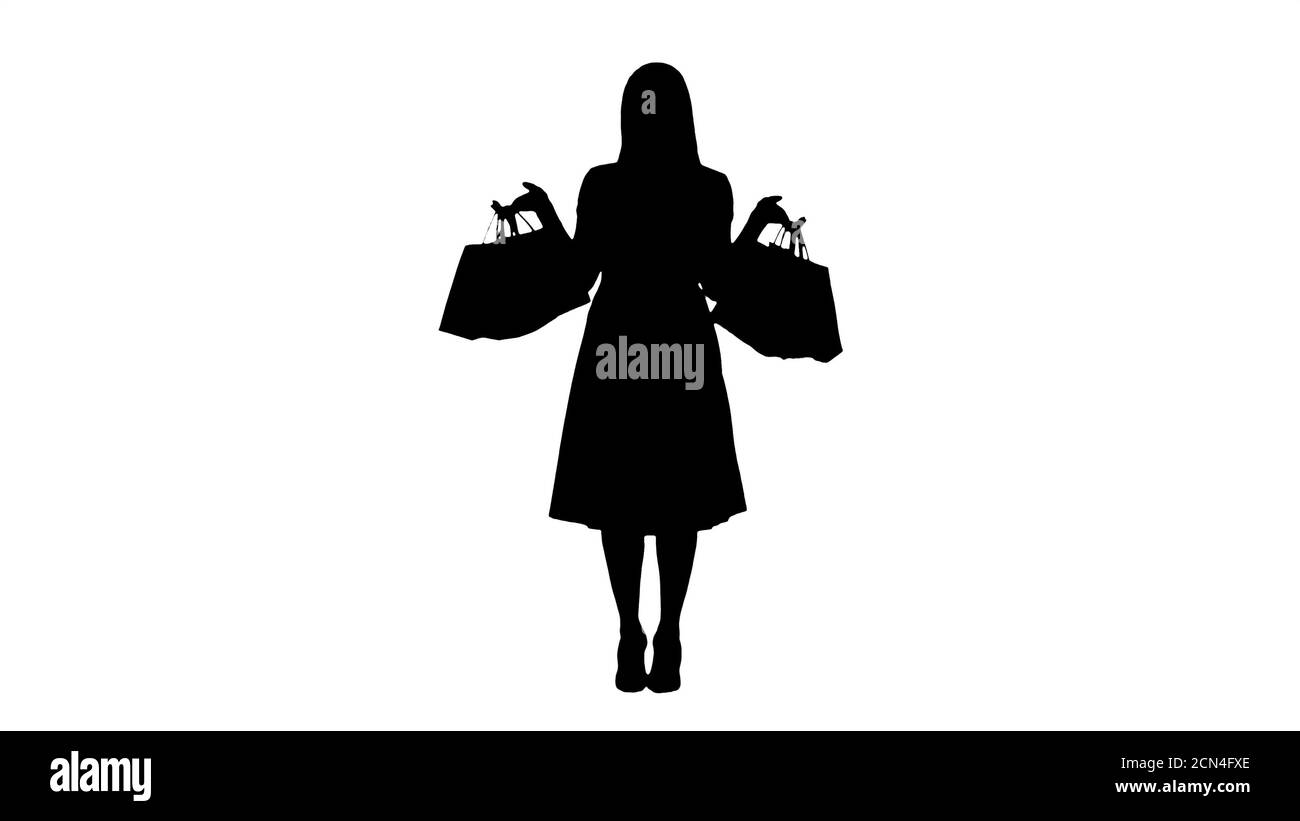 Silhouette Woman with shopping bags in pink dress standing. Stock Photo