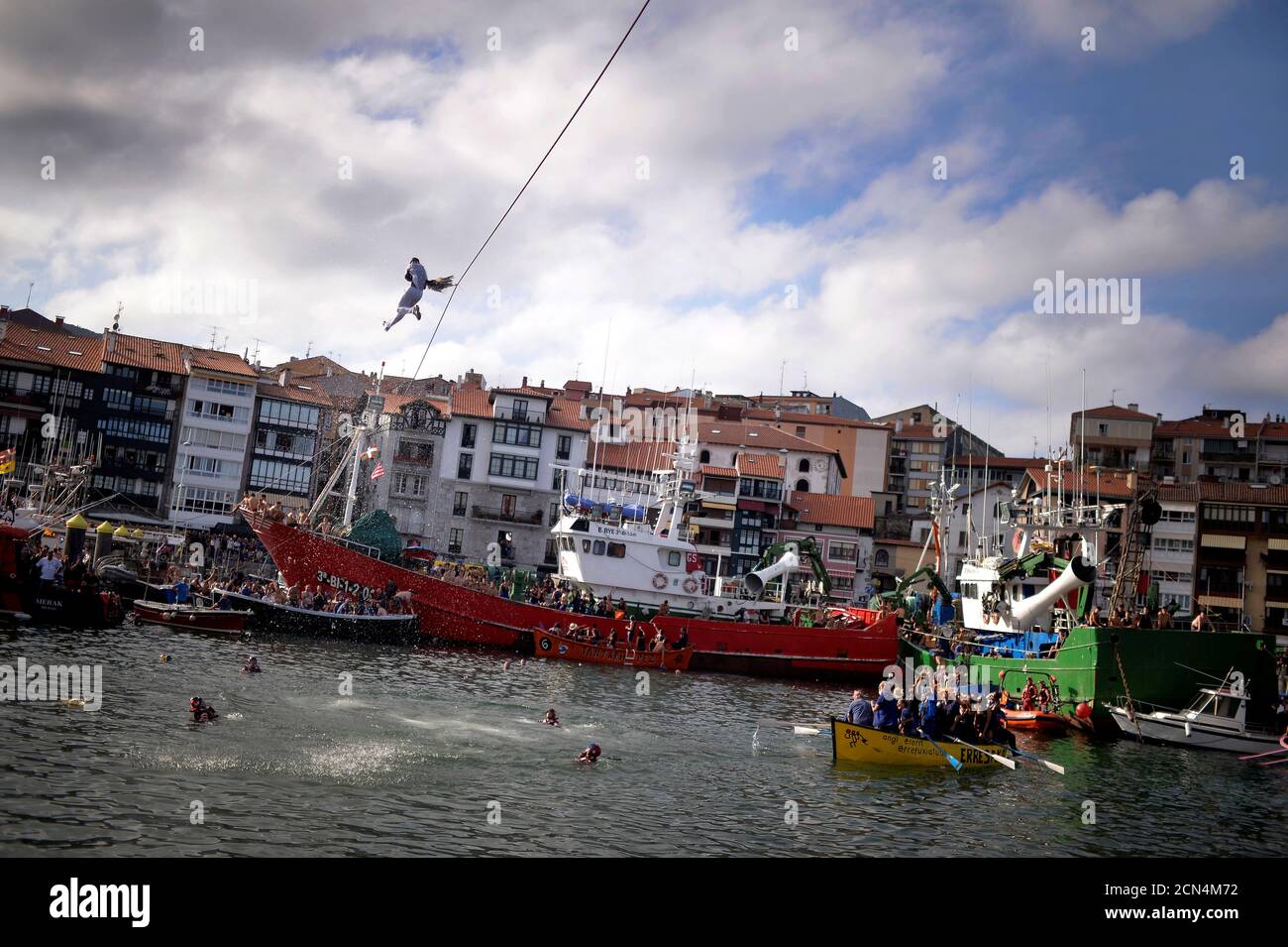 A man attempts to pull the neck off a dead goose while being repeatedly  plunged into the water during Antzar Eguna (Day Of The Goose) in the Basque  fishing town of Lekeitio,
