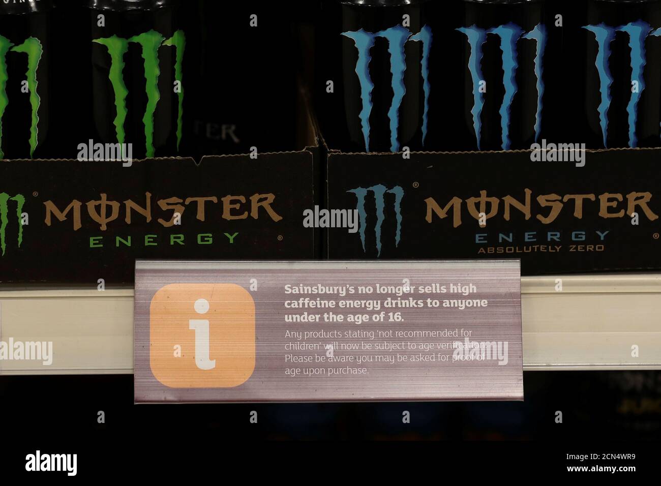 A sign stating the energy drinks will not be sold to anyone under 16 sits next to cans of Monster at a Sainsbury's store in London, Britain, August 30, 2018. REUTERS/Simon Dawson Stock Photo