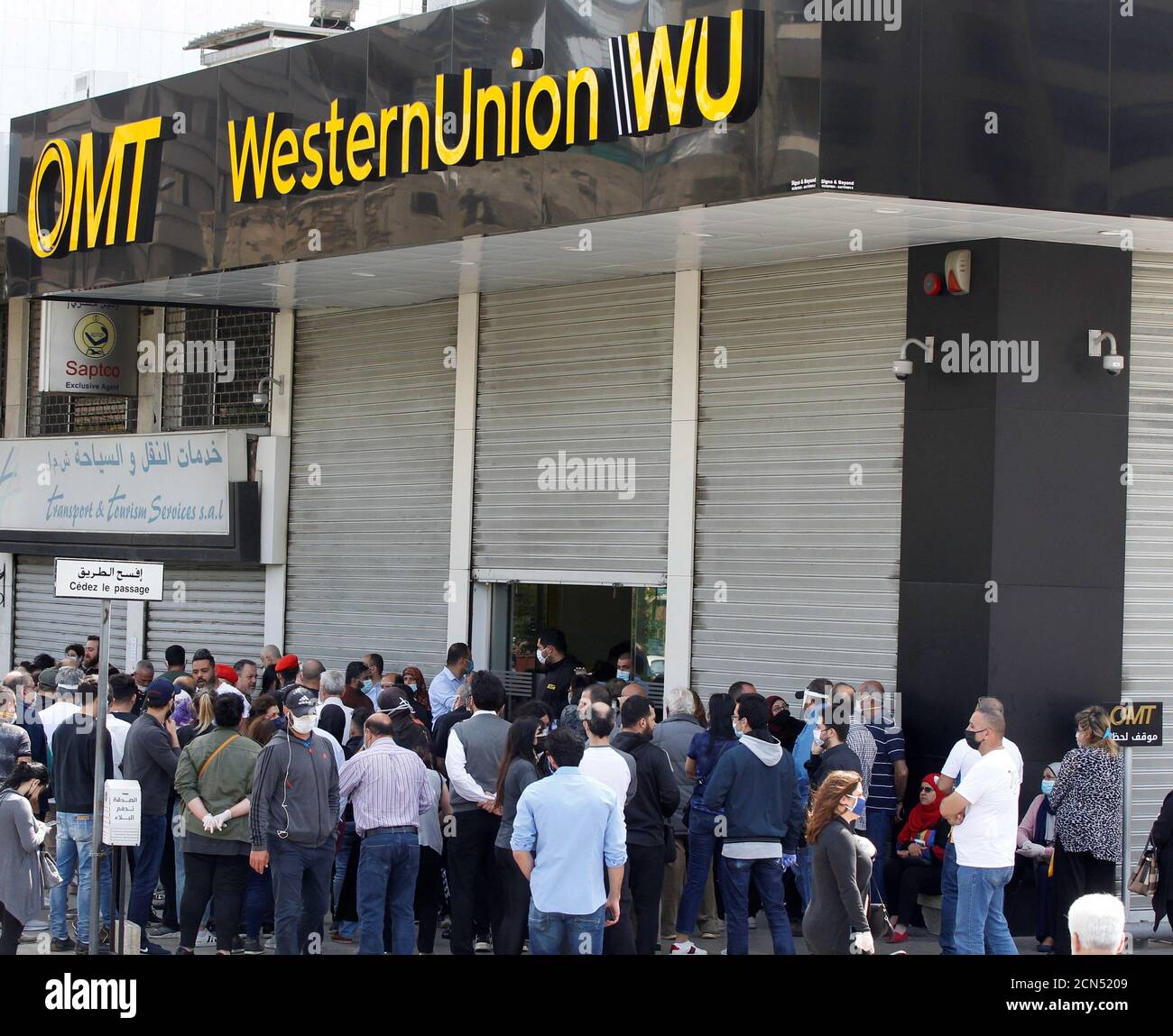 Crowds form outside the money transfer offices of Western Union and OMT  after customers were informed it was the last day to retrieve transfers in  dollars, in Beirut, Lebanon April 23, 2020.