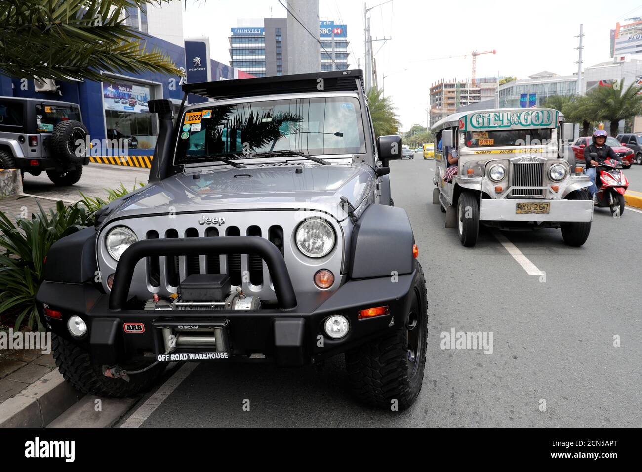A Philippine made passenger jeepney drives past a . made Jeep Wrangler SUV outside a local dealer of . made vehicles, Automotive Icon in Alabang, Metro Manila, Philippines August 15, 2018. REUTERS/Erik A Philippine made passenger jeepney drives past a . made Jeep Wrangler SUV outside a local dealer of . made vehicles, Automotive Icon in Alabang, Metro Manila, Philippines August 15, 2018. REUTERS/Erik
