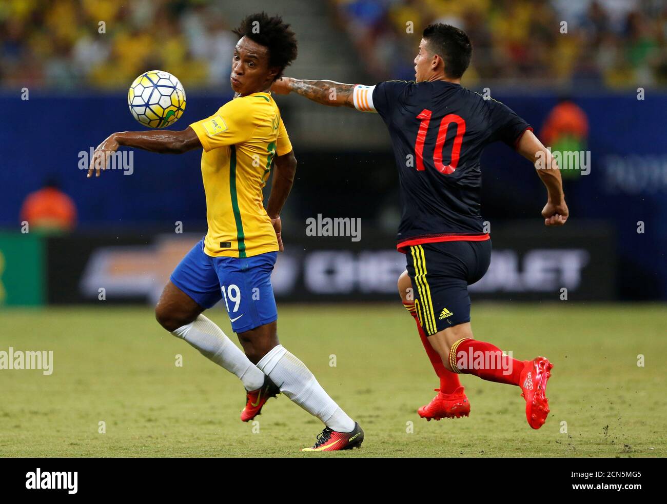 Football Soccer - World Cup 2018 Qualifiers - Brazil v Colombia - Amazonia Arena Stadium, Manaus, Brazil - 6/9/16. Willian (L) of Brazil in action with James Rodriguez of Colombia.   REUTERS/Bruno Kelly Stock Photo