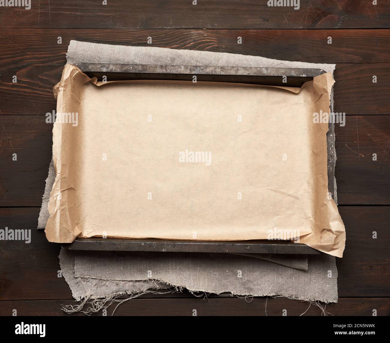 empty rectangular metal pan covered with brown parchment paper Stock Photo
