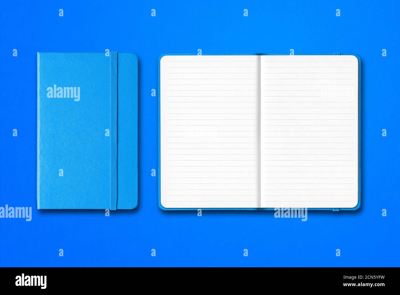 Cyan closed and open lined notebooks isolated on blue background Stock Photo