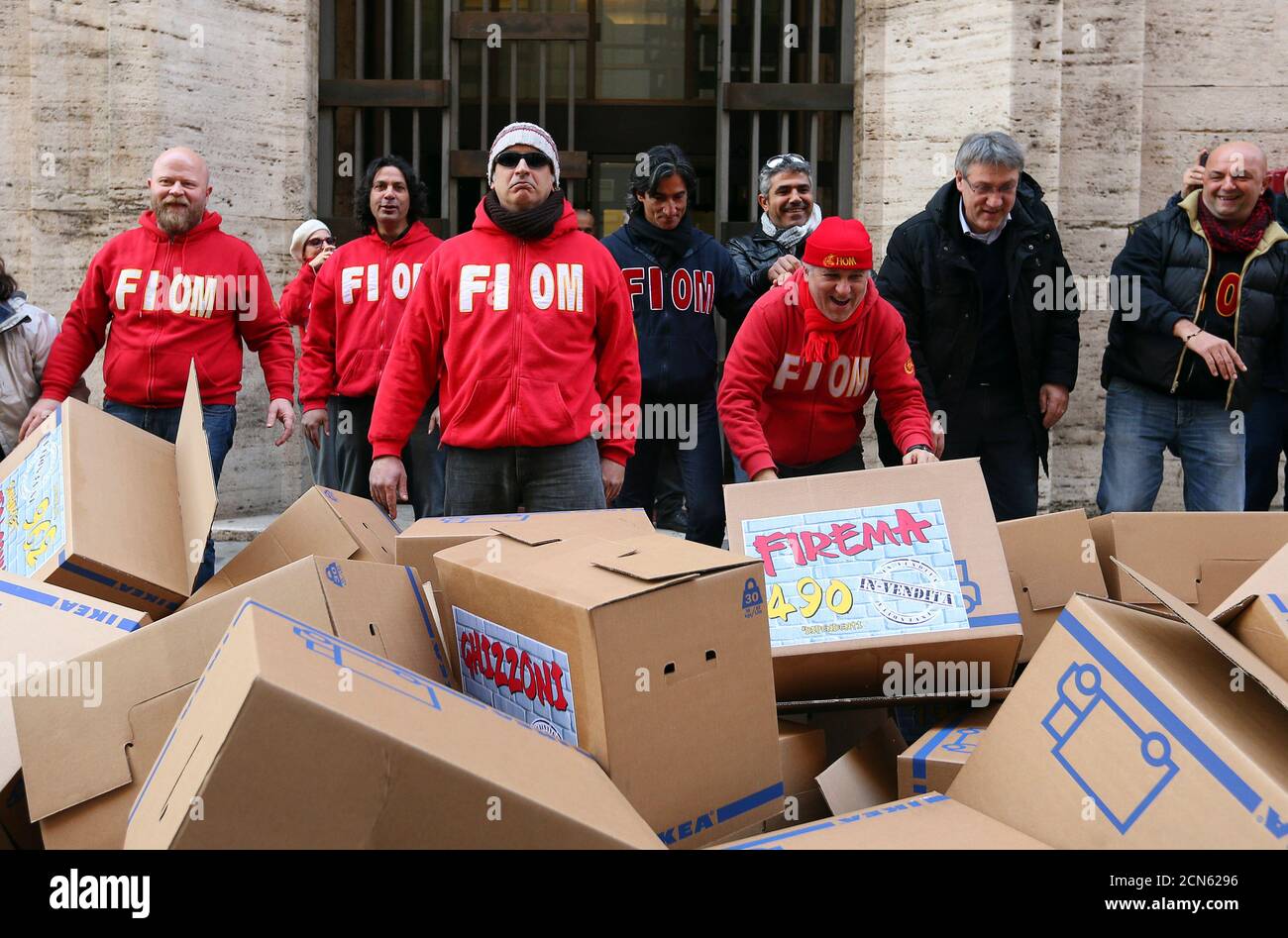 Union workers stand in front of boxes during a protest organised by FIOM union in front of the Ministry of Labour in Rome December 11 ,2013. Prime Minister Enrico Letta called on parliament on Wednesday to back his government or risk chaos as he sought to push through long-avoided reforms intended to revive Italy's economy after two years of recession. REUTERS/Remo Casilli (ITALY - Tags: BUSINESS CIVIL UNREST POLITICS EMPLOYMENT) Stock Photo
