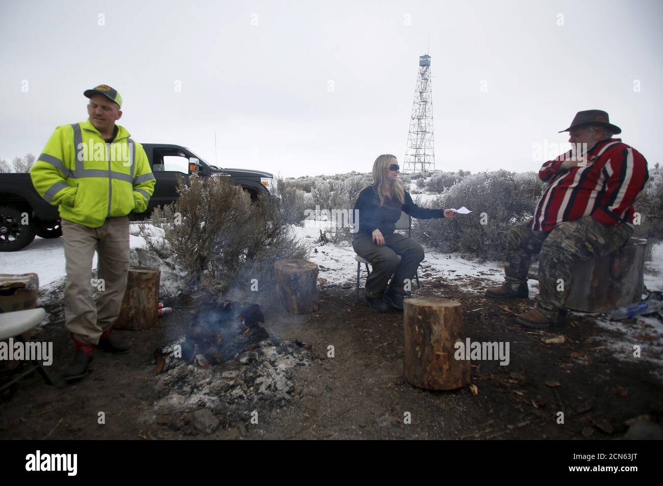 Occupiers sit by a fire at the Malheur National Wildlife Refuge near Burns, Oregon, January 10, 2016. Members of self-styled militia groups met on Friday with armed protesters occupying the federal wildlife refuge in Oregon, pledging support for their cause, if not their methods, and offering to act as a peace-keeping force in the week-long standoff over land rights. REUTERS/Jim Urquhart Stock Photo