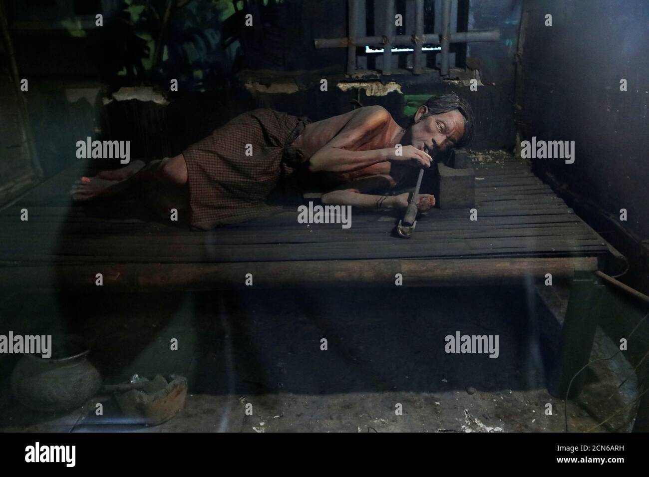 A mock-up of a man smoking opium is seen at the Drug Elimination museum in Yangon, Myanmar November 6, 2018. REUTERS/Ann Wang Stock Photo