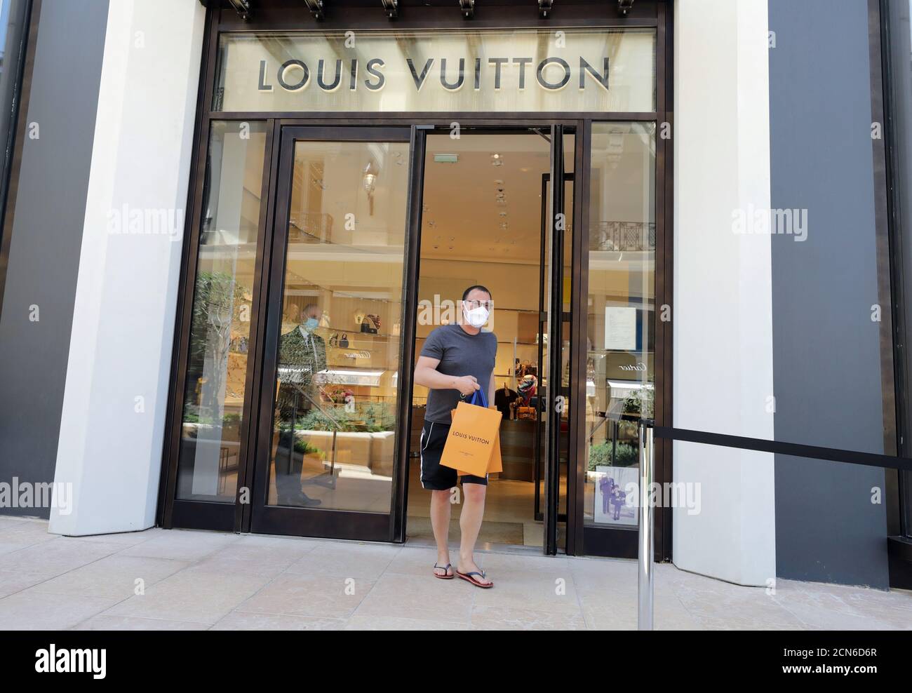 A wearing a protective face mask, leaves a Louis Vuitton shop in Monte Carlo after lockdown restrictions were partially lifted the coronavirus disease (COVID-19) outbreak in Monaco, May 7, 2020.