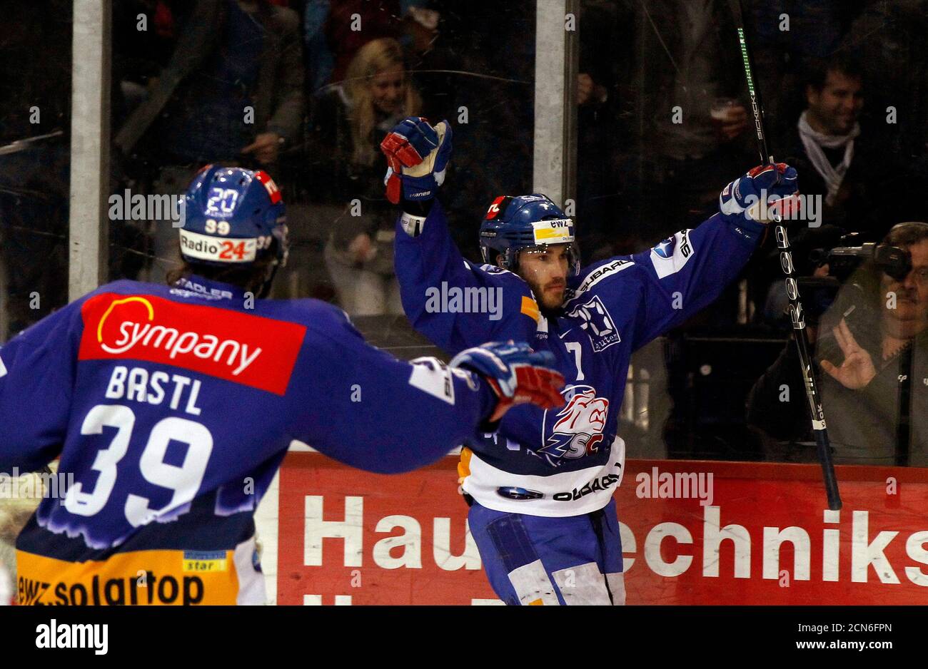 ZSC Lions' Thibaut Monnet celebrates with his teammate Mark Bastl (L) after scoring during their Swiss ice hockey play-off final against SC Bern (SCB) at the Hallenstadion arena in Zurich April 14, 2012. REUTERS/Arnd Wiegmann (SWITZERLAND - Tags: SPORT ICE HOCKEY) Stock Photo