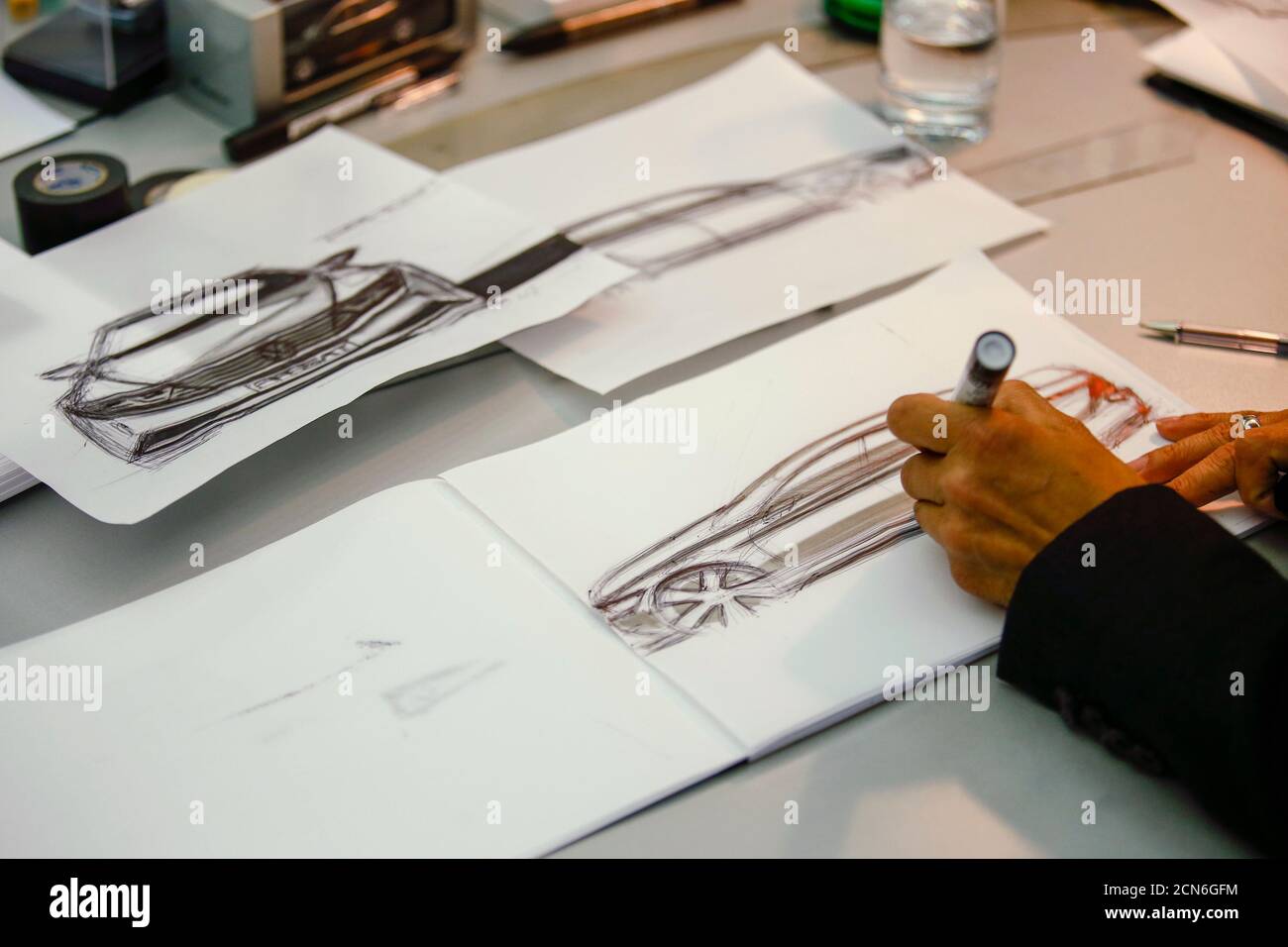 A man drafts a sketch of a car in a showcase design studio at the fringes  of a launch ceremony presenting the new Volkswagen Passat at the Volkswagen  Design Center Potsdam July