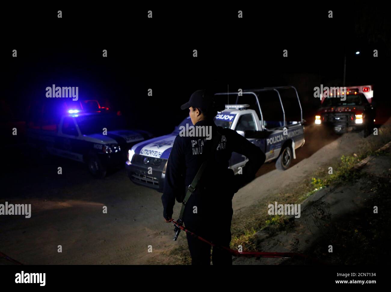 A federal police stands guard on a street after dangerous radioactive  medical material were found on a truck in the town of Hueypoxtla, near  Mexico City December 4, 2013. Mexican police have