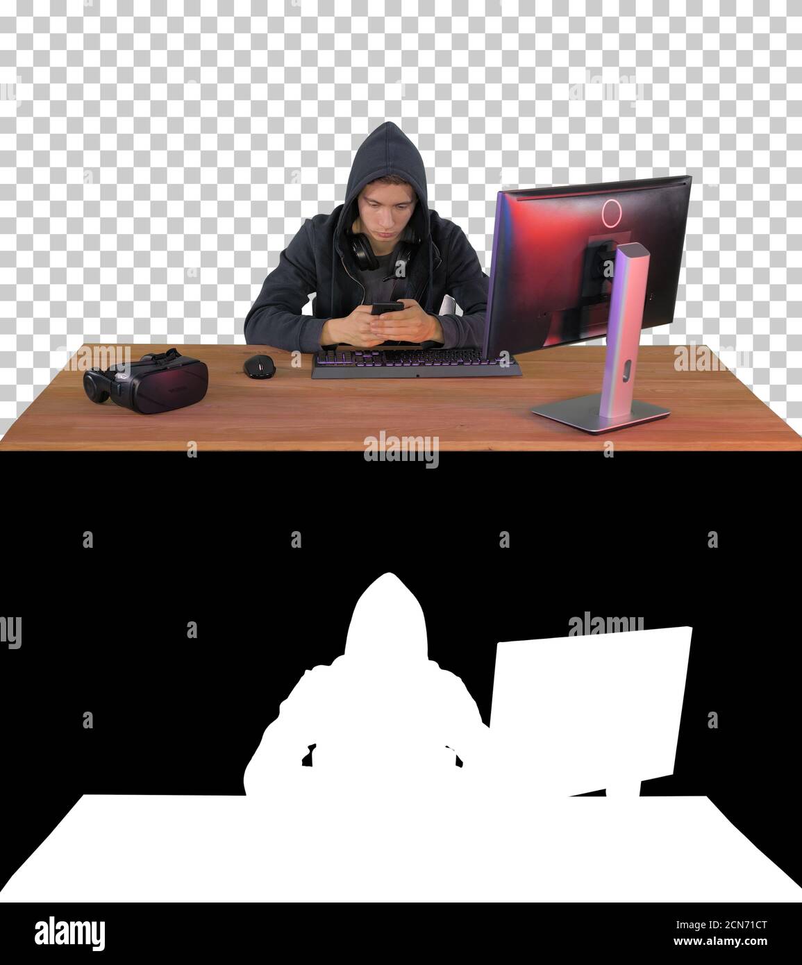 Hooded hacker using laptop and smartphone, Alpha Channel with Si Stock Photo