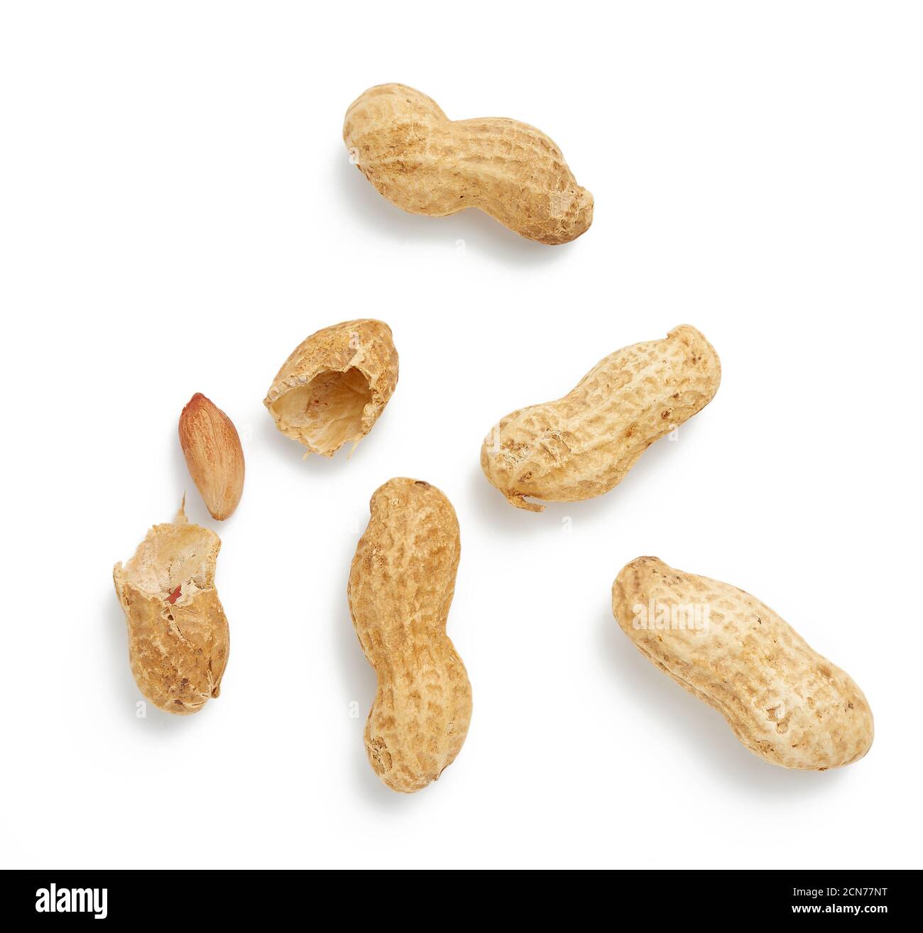 heap of peanuts in shell and broken, food isolated on white background, close up Stock Photo