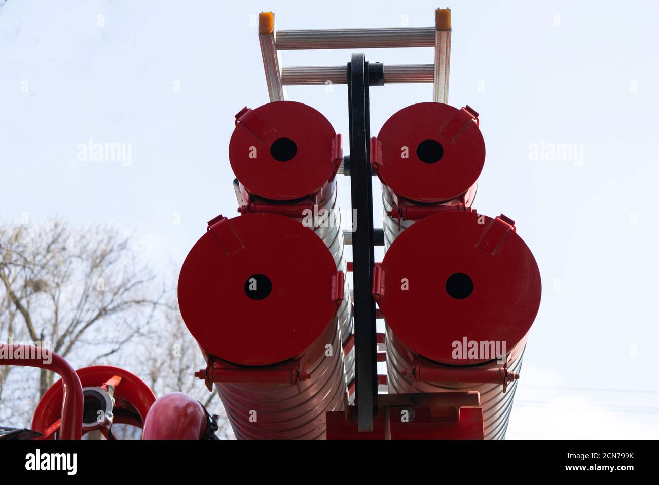 a fire truck, rear view of canisters for transporting suction hoses with fire escapes attached to them Stock Photo