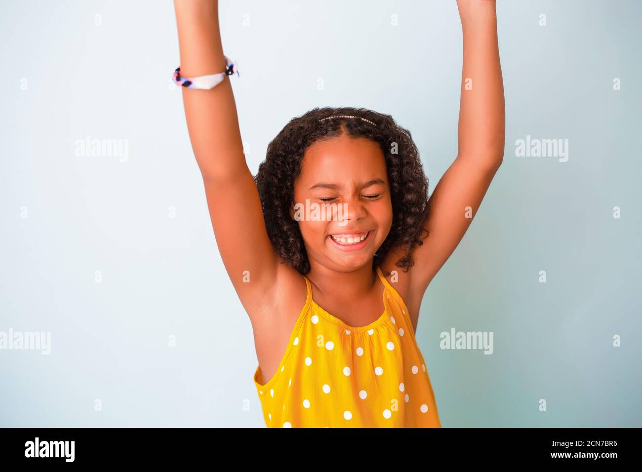 Happy African American Girl With arms up Stock Photo - Alamy