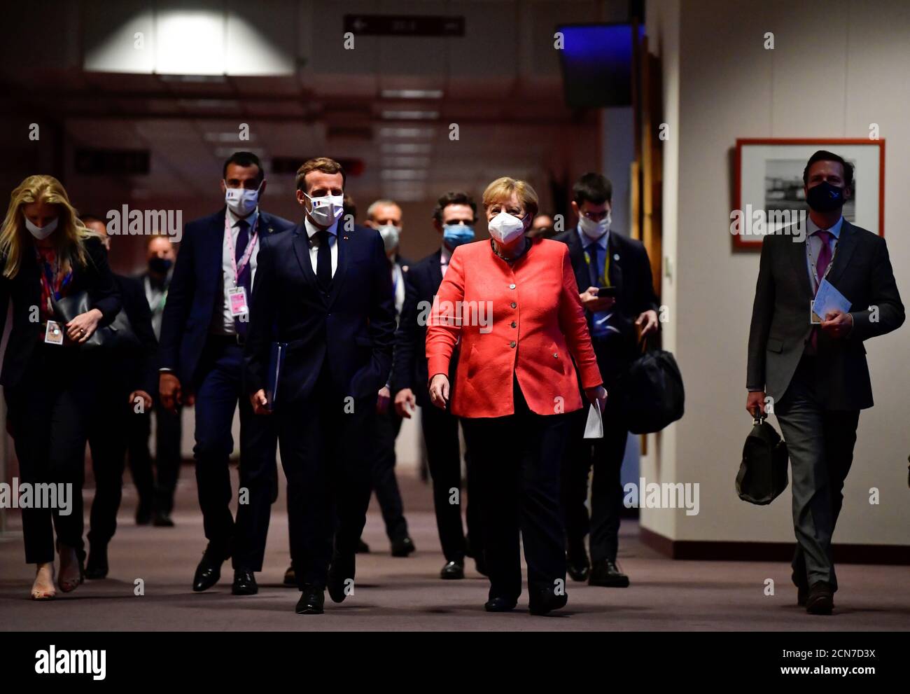 German Chancellor Angela Merkel (R) and French President Emmanuel Macron (L) arrive for a joint press conference at the end of the European summit at the EU headquarters in Brussels on July 21, 2020 . John Thys/Pool via REUTERS Stock Photo