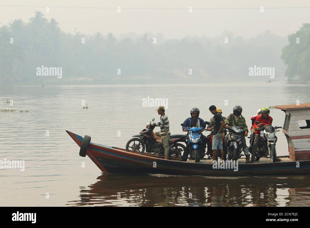 Motorcyclists Cross Rokan River On A Wooden Boat During Haze In Rokan Hilir On Indonesia S Riau Province June 24 2013 Malaysia Declared A State Of Emergency In Two Parts Of The Southern<script async src=