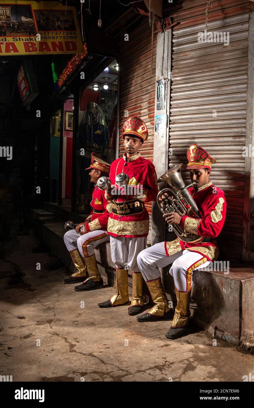 Three Indian wedding band musicians practicing their daily music