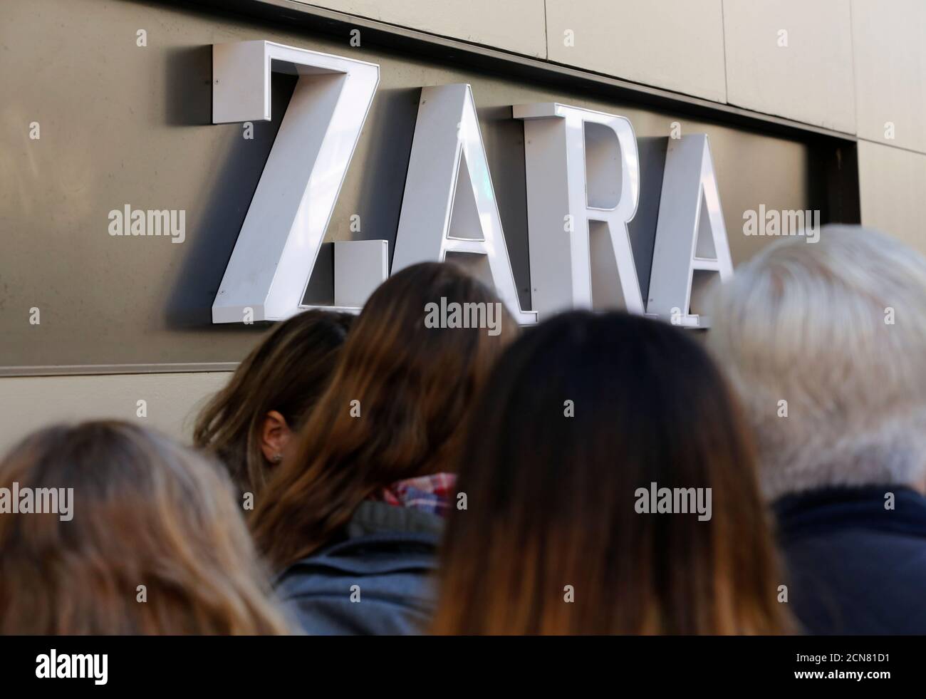 People walk past a Zara logo in the Andalusian capital of Seville, southern  Spain March 3, 2016. REUTERS/Marcelo del Pozo Stock Photo - Alamy