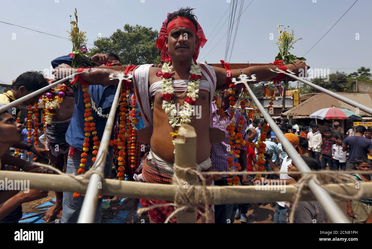 A Hindu devotee is seen nailed to a cross during the annual Shiva Gajan  religious festival in Batanal village in West Bengal, India, April 13,  2016. Hundreds of faithful devotees offer sacrifices