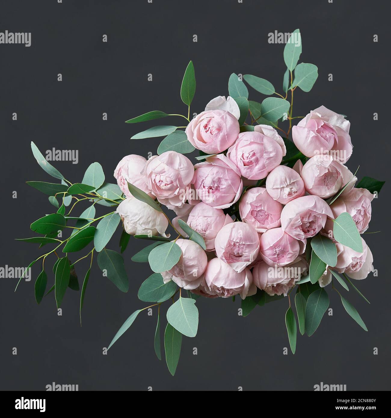 Beautiful bouquet of flowers with pink roses and green eucalyptus leaves. Stock Photo