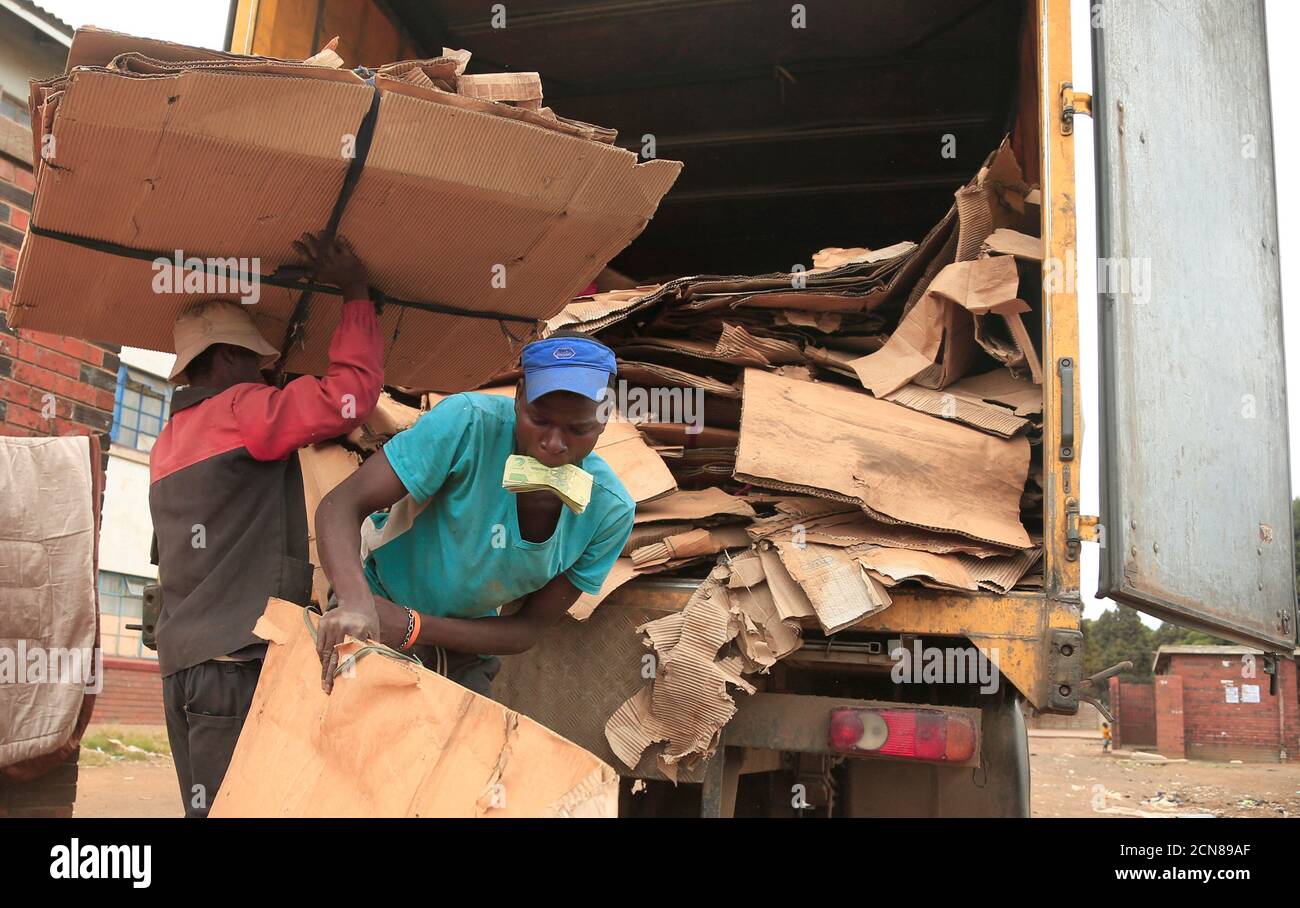 People remove the remains of their vending stalls after they were destroyed by police during a nationwide lockdown called to help curb the spread of coronavirus disease (COVID-19) in Harare, Zimbabwe, April 19, 2020. REUTERS/Philimon Bulawayo Stock Photo