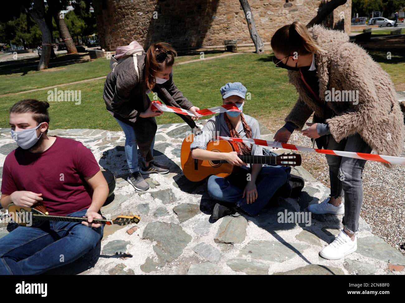 Musicians wearing protective face masks gather around the White Tower during a protest by workers in the music industry in demand of state aid to mitigate financial losses due to the coronavirus disease (COVID-19) outbreak, in Thessaloniki, Greece, May 7, 2020. REUTERS/Murad Sezer Stock Photo
