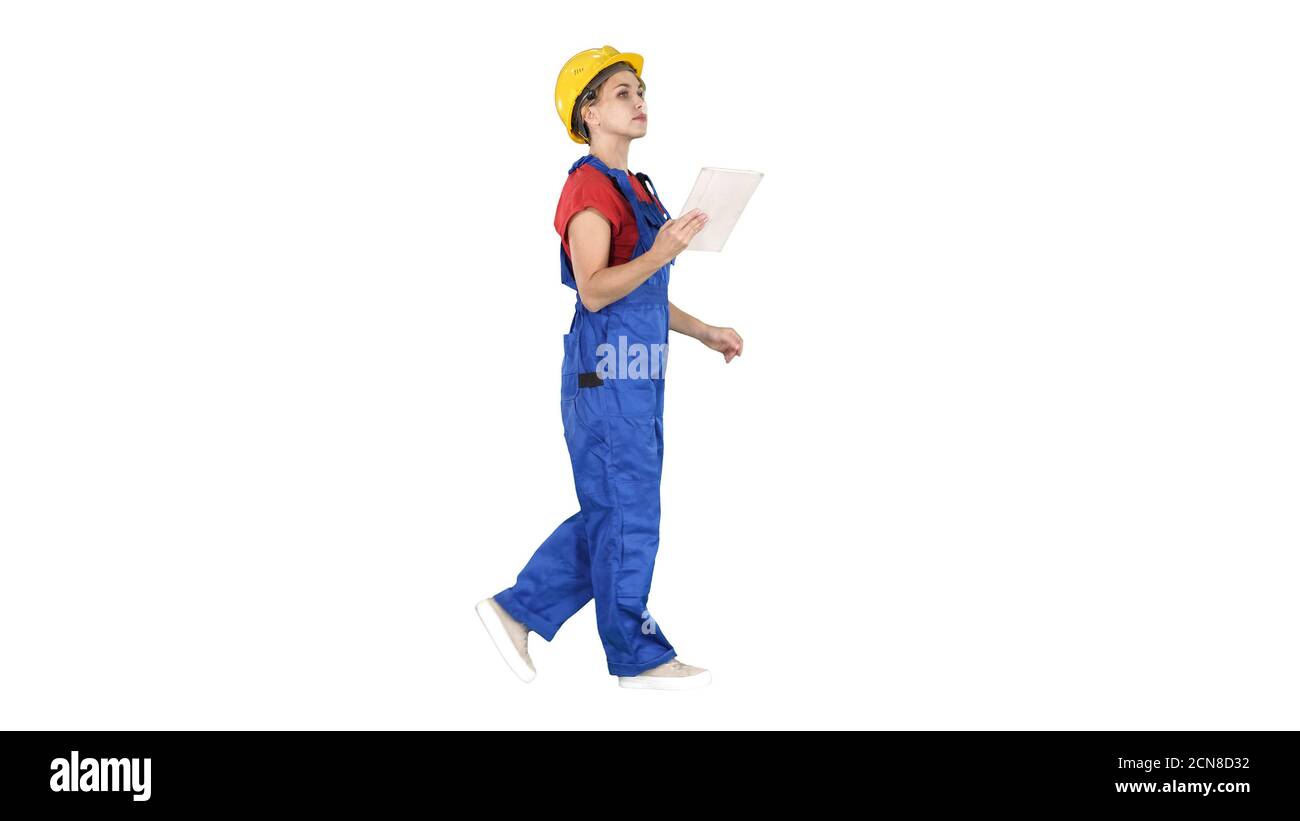 Construction lady using electronic tablet walking on white backg Stock Photo