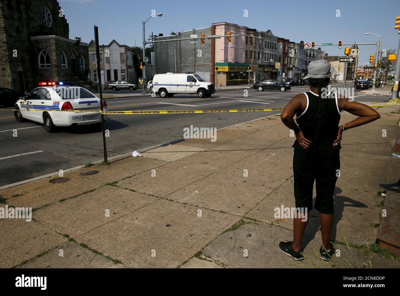 A resident in the neighborhood where Freddie Gray was arrested and where residents rioted over his death in April look on at the scene of a shooting at the intersection of West North Avenue and Druid Hill Avenue in West Baltimore, Maryland May 30, 2015. Local media have reported more than 35 murders in the city of Baltimore since the April rioting over the death of 25-year-old resident Freddie Gray and shootings continue regularly in his West Baltimore neighborhood.  REUTERS/Jim Bourg Stock Photo
