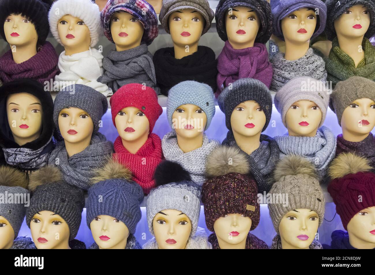 Mannequin heads in knitted hats and scarves. Stock Photo