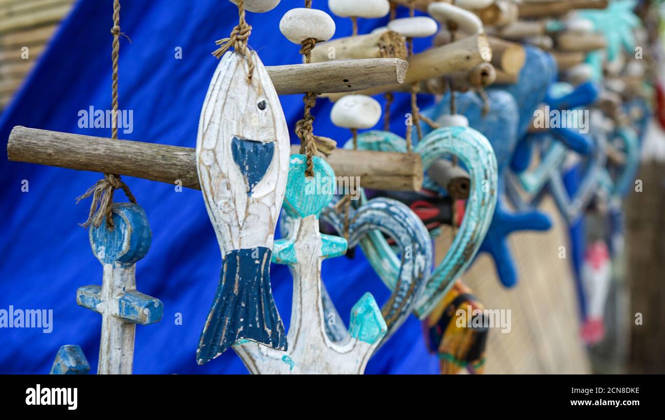 Close up of a fish-shaped wooden hanging ornament Stock Photo