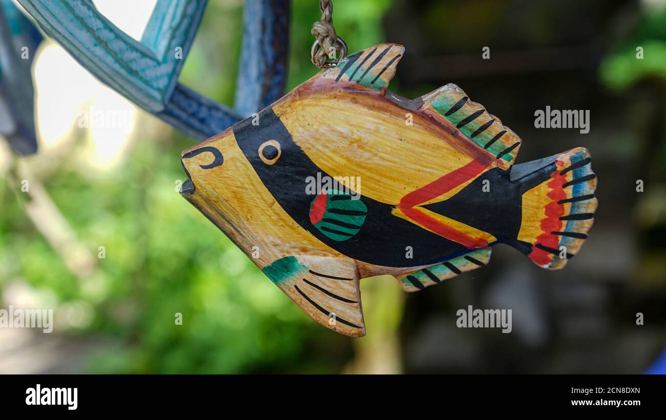 Close up of a fish-shaped wooden hanging ornament Stock Photo