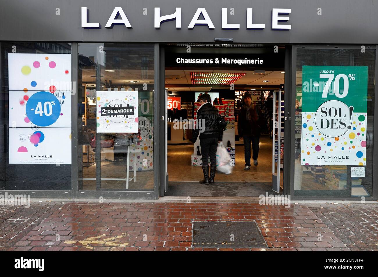 People enter a shoes store of the brand "La Halle aux chaussures", owned by  the Vivarte Group, a French giant ready-to-wear apparel and footwear  retailer, in Strasbourg, France, January 24, 2017. REUTERS/Vincent