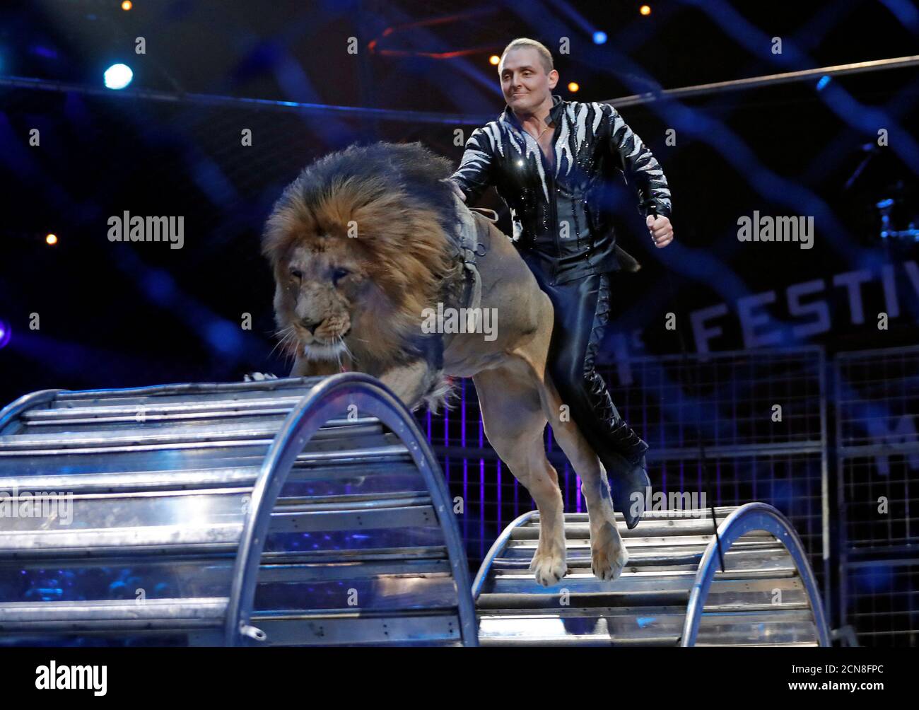 Zapashny brothers, winners of a Silver Clown award, perform with a lion at  the gala of the 41st Monte-Carlo International Circus Festival in Monaco  January 24, 2017. REUTERS/Eric Gaillard Stock Photo -