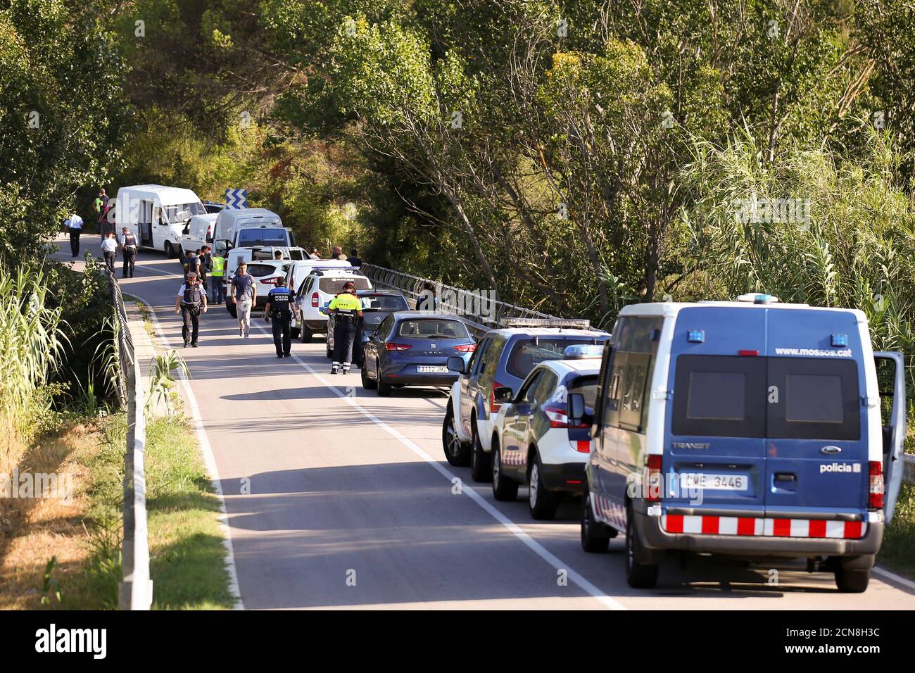Catalan Mossos d'Escuadra vans are parked along a road near the place where Younes Abouyaaqoub, the man suspected of driving the van that killed 13 people in Barcelona last week, was killed by police in Sant Sadurni d'Noia, Spain, August 21, 2017. REUTERS/Albert Gea Stock Photo