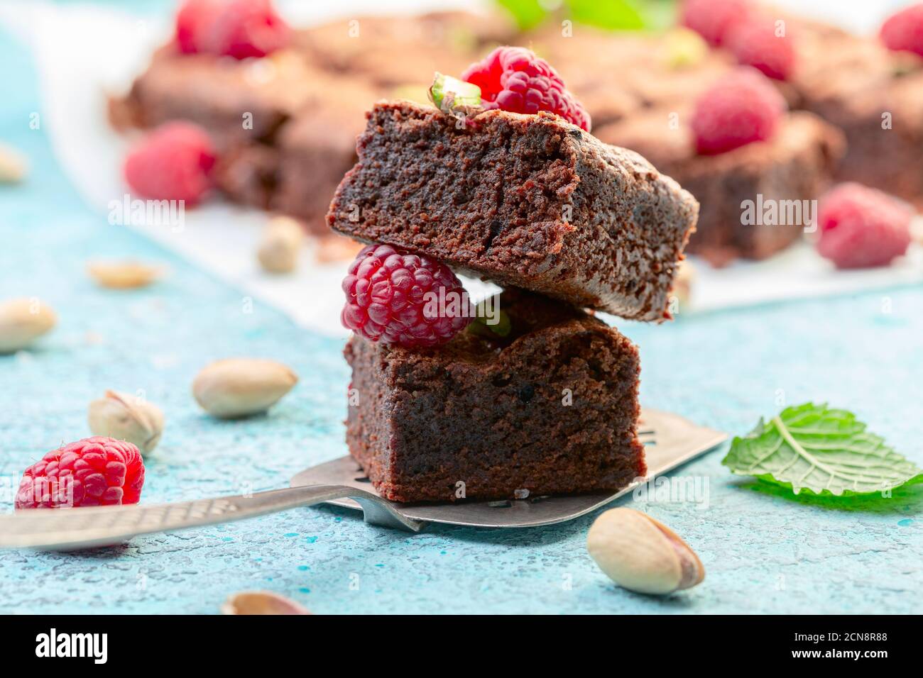 Brownie slices with raspberries and pistachios. Stock Photo
